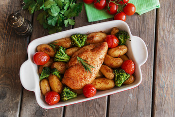 Chicken breast baked with tomato new potatoes and broccoli