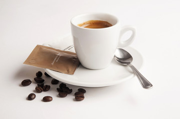 Coffee cup with sugar and coffee beans on white background