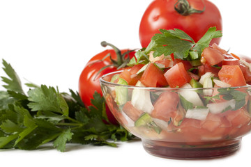 a bowl of salsa with tomato and celery