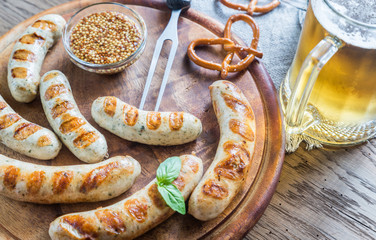Grilled sausages with pretzels and mug of beer