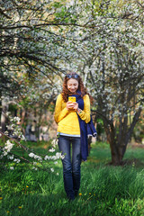technology and people concept - smiling young woman texting on smartphone