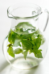 Water with fresh basil in the glass jug