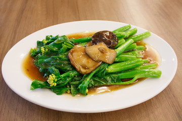 Stir-fried chinese broccoli and shiitake mushroom in oyster sauc