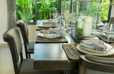 table set on wooden table and chairs in tropical dinning room