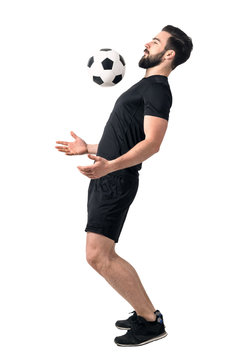 Soccer futsal player stopping the ball with his chest. Full body length portrait isolated over white background.