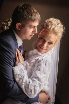 portrait of the bride and groom in love in the room with natural lighten. happy wedding day