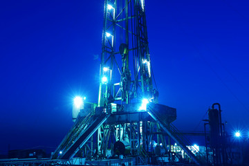 Tall oil derrick, at night