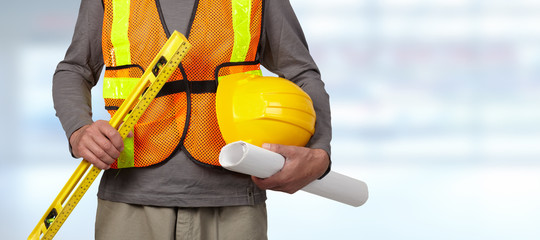 Worker with helmet in orange security vest.