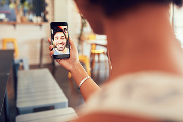 Woman having a video call with man on her smart phone