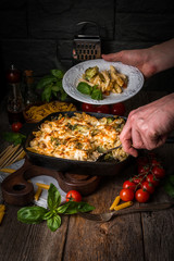 Baked pasta with broccoli, cauliflower, cheese and bechamel sauc