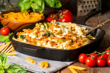 Baked pasta with broccoli, cauliflower, cheese and bechamel sauc