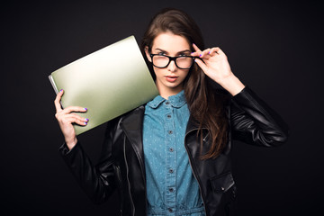 Naklejka premium Beautiful young woman in glasses on a black background