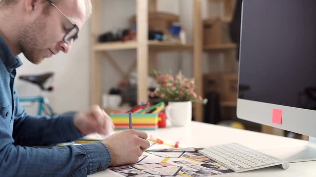 stylish architect working on blueprint