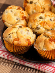 Savory muffins with ham, cheese dried tomatoes, vertical shot