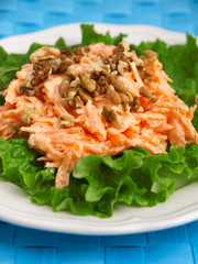 Coleslaw salad with walnuts over fres lettuce. Vertical shot