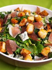 French Provencal Salad with green salad, bacon, croutons and blue cheese. Close up