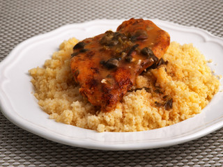 Couscous with curry, chicken fillet and mushrooms sauce. Horizontal shot