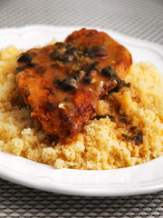 Couscous with curry, chicken fillet and mushrooms sauce. Vertical shot