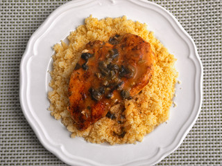 Couscous with curry, chicken fillet and mushrooms sauce. Shot from above. Horizontal shot shot