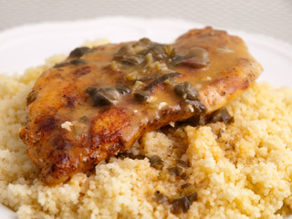 Couscous with curry, chicken fillet and mushrooms sauce. close up shot