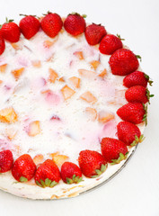 Cake with strawberries, gelly yogurt and cherries shot from above. Cropped view. Isolated on white background