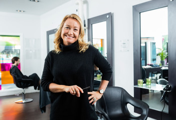Hairstylist Holding Scissor While Standing In Salon