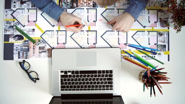 top view. stylish architect working on blueprint