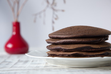 Chocolate pancake on a light background