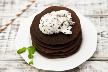 Chocolate pancake with icecream on a light background