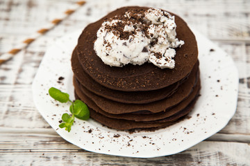 Chocolate pancake with icecream on a light background