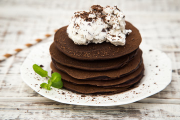 Chocolate pancake with icecream on a light background