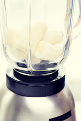 close up of blender shaker with bananas