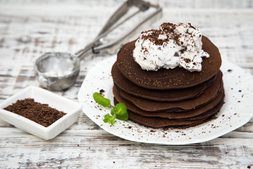Chocolate pancake with icecream on a light background
