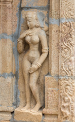 Fototapeta na wymiar Trichy, India - October 15, 2013: Sandstone statue of naked woman at Ranganathar Temple. Outside wall of old part built during Madurai Nayak era.