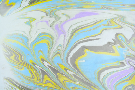 Ebru art. Traditional Turkish Ebru technique. Marbling painting on water transferred on highly textured paper or cloth. Color paint ebru with waves and tile pattern.