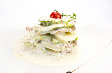 Herring salad with avocado sauce on a plate in a restaurant