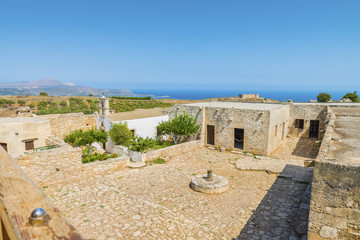 Picturesque old Monastery of Saint John Theologian in Ancient Aptera town at Crete island.The panoramic view from the height on the buildings,ruins and fortress on the Mediterranean sea Greece.Europe.