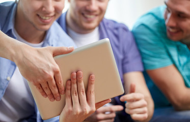 close up of happy friends with tablet pc at home