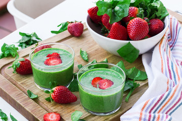 Green spinach smoothie with strawberry