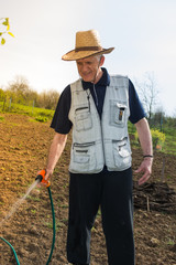 Farmer watering crops