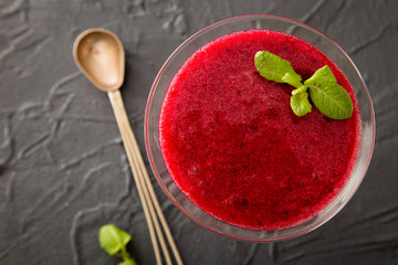 red smoothie with frozen berries, selective focus, top view. detox koncept