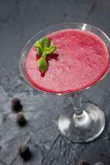 red smoothie with frozen berries, selective focus, top view. detox koncept