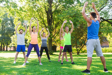 group of friends or sportsmen exercising outdoors