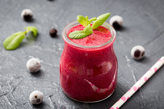 red smoothie with frozen berries, selective focus, top view. detox koncept