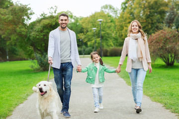 happy family with labrador retriever dog in park