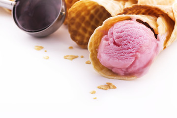 Portion of homemade berry pink ice cream and waffle cones
