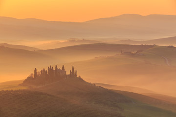 Misty sunrise in the Val d’Orcia, or Valdorcia, a region of Tuscany, central Italy, which extends from the hills south of Siena to Monte Amiata. 