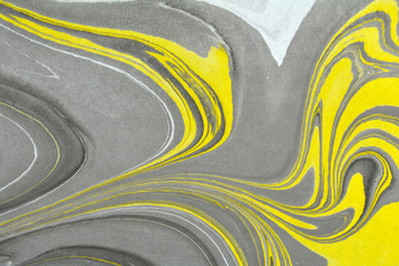 Abstract background. Ink marbling texture. Grey, yellow and white. Hand drawn marble illustration, ebru aqua paper and silk print. Traditional Turkish ebru technique. Painting on water. 