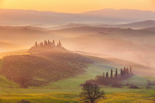 Misty sunrise in the Val d&rsquo;Orcia, or Valdorcia, a region of Tuscany, central Italy, which extends from the hills south of Siena to Monte Amiata. 