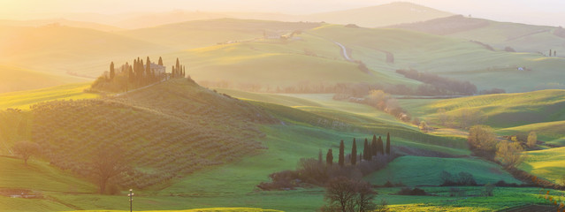 Misty sunrise in the Val d’Orcia, or Valdorcia, a region of Tuscany, central Italy, which extends from the hills south of Siena to Monte Amiata. 